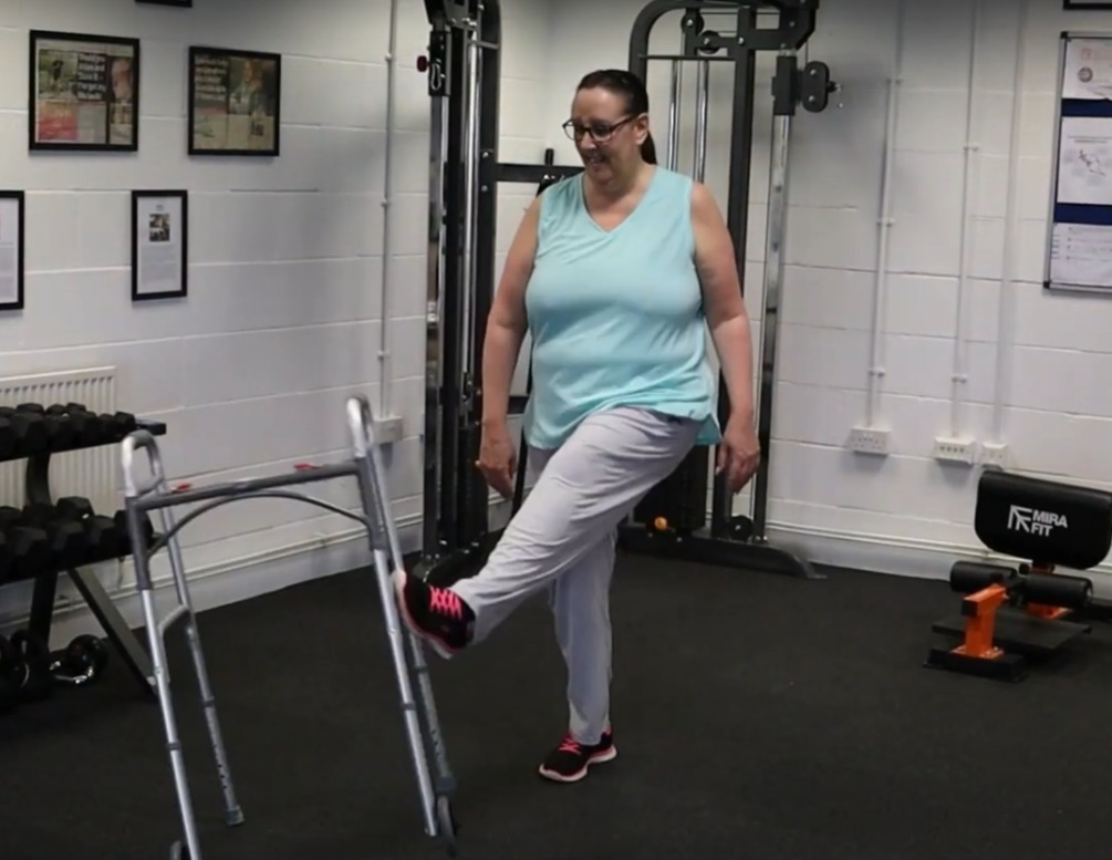 A woman kicking a walking frame during her fibromyalgia recovery