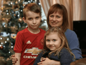 A Woman with Fibromyalgia folding her grandchildren