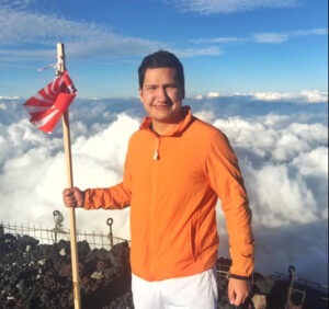 A young man on top of a mountain