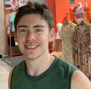 A man in a green shirt smiling