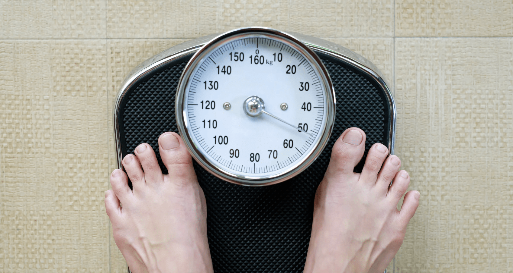 Male feet stood on weight scales